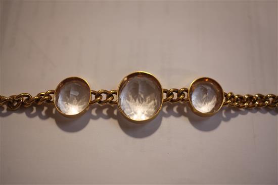 An early 20th century 15ct gold chain link bracelet set with three oval facet cut rock crystals, in fitted C. Packer & Co box,